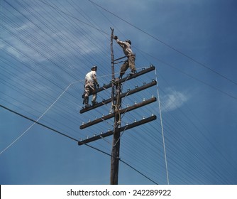 The Investment Made In TVA Public Works Projects During The Great Depression Paid Off In World War II. Photo Shows 1942 Construction Of Telephone Lines Near A TVA Dam Hydroelectric Plant.