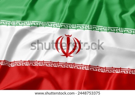 Iran flag blowing in the wind. Close up, soft and smooth silk. Fabric texture banner background. Use it for the concept of national day and occasions in the country