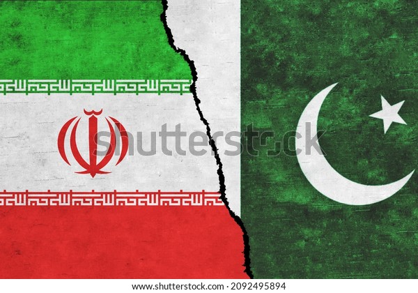 Iran and Pakistan painted flags on a wall with a\
crack. Pakistan and Iran relations. Iran and Pakistan flags\
together. Iran vs\
Pakistan