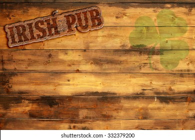 Irish Pub Label And Green Shamrock On Wooden Background