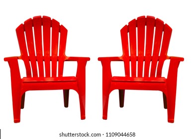 Isolated Closeup Of Two Bright, Vibrant Red Adirondack Chairs Turned Very Slightly Inward, Toward Each Other, With Seats Facing Viewer. Chairs Are Set Against A Solid White Background.