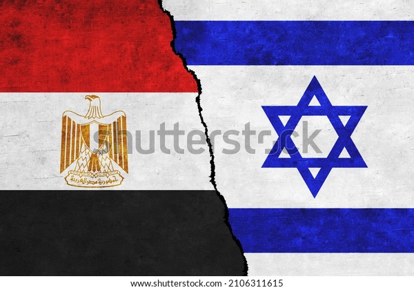 Israel and Egypt painted flags on a wall with a\
crack. Israel and Egypt conflict. Egypt and Israel flags together.\
Egypt vs Israel
