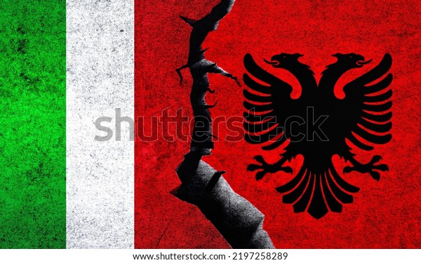 Italy vs Albania flags on a wall with crack.\
Albania Italy relations. Italy Albania conflict, war crisis,\
economy, relationship, trade\
concept