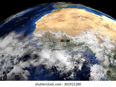 Ivory Coast flag on pole on earth globe illustration - Elements of this image furnished by NASA