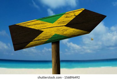 Jamaica Wooden Sign With A Beach On Background - Central America