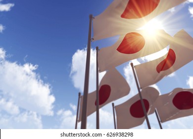 Japan flags waving in the wind against a blue sky. 3D Rendering
