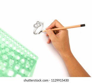 Jewelry designers are painting the ring with a pencil on a piece of paper before the model can be produced.