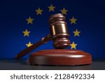 Judges wooden gavel with EU flag in the background. Region court system. 3d render