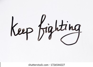 Keep Fighting Handwritten Message On A White Background.