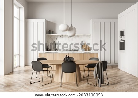 Kitchen interior with unusual white cabinet design, having simplistic upper part, two pendant lamps and a wooden dining table with black chairs. Parquet. Minimalistic concept. 3d rendering Foto stock © 