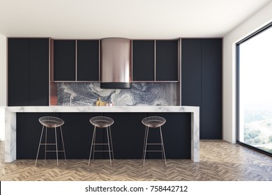 Kitchen interior with a wooden floor, black countertops and cupboards with built in appliances. A marble bar stand with round stools in the foreground. 3d rendering mock up