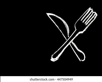 Knife and fork with hand drawn in chalk icon on blackboard.