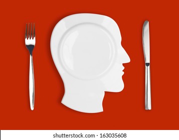 Knife, head plate and fork on red background