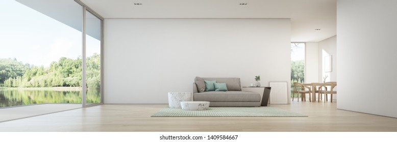 Lake View Dining And Living Room Of Luxury Summer House With Wooden Terrace. Gray Sofa In Vacation Home Or Holiday Villa. Hotel Interior 3d Illustration.