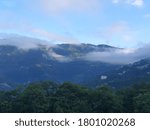 landscape of clouds floating over the hills 