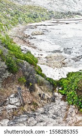 Landscape with a rocky path down to the beach
