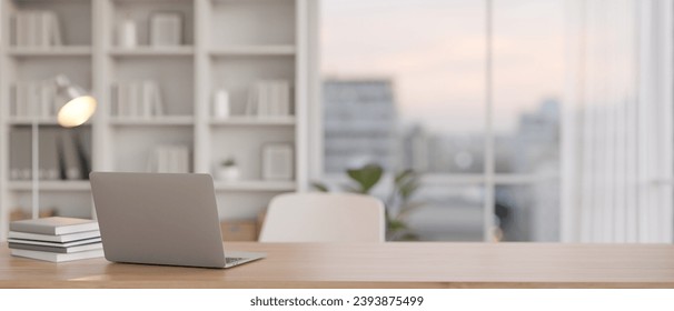 Laptop computer mockup on a wooden tabletop in a minimal office room with city view. 3d render, 3d illustration - Powered by Shutterstock