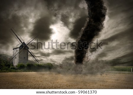 Large tornado over a wind mill