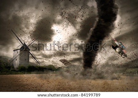 Large tornado over a wind mill