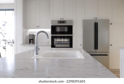 Large white kitchen with island and all necessary appliances. 3d rendering. Emphasis on a stone top with white marble, in the background is an oven, a sink from a mixer and a refrigerator. - Shutterstock ID 2298391601