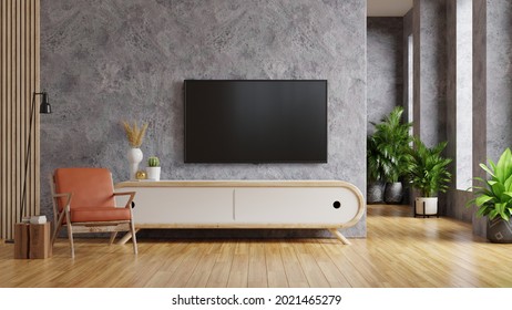 Leather Armchair And A Wooden Cabinet In Living Room Interior With Plant,TV On Concrete Wall.3d Rendering