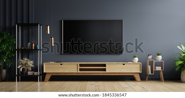 LED TV on the dark wall in living\
room with wooden cabinet,minimal design,3d\
rendering