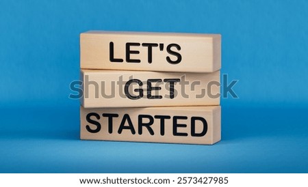 Lets get started symbol. Concept words Lets get started on wooden blocks.Business and Lets get started concept. Copy space.3D rendering on blue background.
