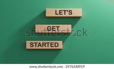 Lets get started symbol. Concept words Lets get started on wooden blocks.Business and Lets get started concept. Copy space.3D rendering on green background.