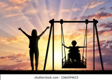 Lifestyle and support for disabled children. Happy child is disabled in a wheelchair on an adaptive swing for disabled children with mom. - Powered by Shutterstock