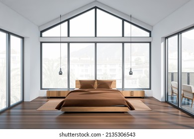 Light bedroom interior, bed with nightstands and carpet on hardwood floor. Balcony and panoramic window on countryside. Sleeping room in modern hotel. 3D rendering