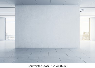 Light Blank Concrete Wall In The Center Of Empty Hall Room With Big Windows And City View. Mockup. 3D Rendering