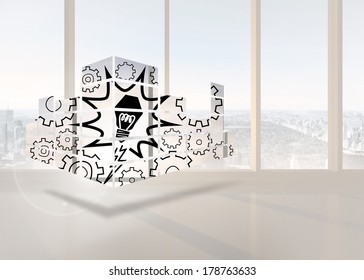 Light bulb on abstract screen against bright white room with windows