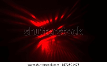 Light particles in motion, creating a burst of glowing multicolored rays on a black background. Energetic glow lights wallpaper.