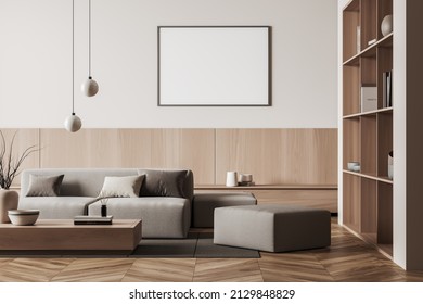 Light relax zone interior with sofa and pouf, coffee table and shelf with books and art decoration, carpet on hardwood floor. Mock up blank poster, 3D rendering