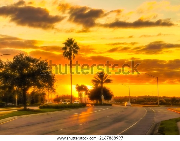Light traffic on suburban parkway, with\
silhouettes of palm and other trees along median strip, under\
glowing sky before sunset in southwest Florida. Digital painting\
effects, 3D\
rendering.