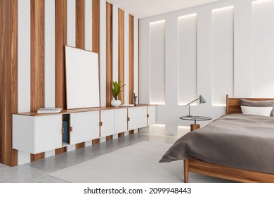 Light wooden bedroom interior with bed and grey linens, side view, commode with decoration. Grey concrete floor with carpet. Mock up frame, 3D rendering