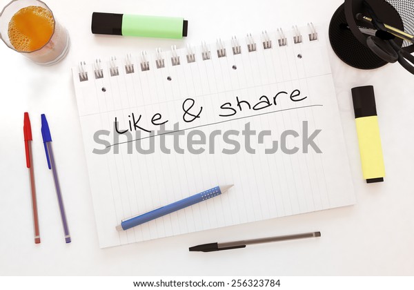 Like and share - handwritten text in a\
notebook on a desk - 3d render\
illustration.