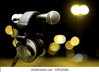 live music  background.Headphones and microphone on the stage - Powered by Shutterstock