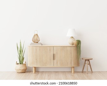 Living room wall mockup in warm interior with wooden slat curved sideboard, trendy green plant in basket and wicker lantern on blank white background. 3D rendering, illustration