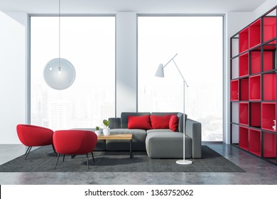 Loft living room interior with white walls, concrete floor, gray sofa and red armchairs near wooden coffee table and red bookcase. 3d rendering