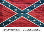 Logo of Confederate flag projected on a sunny brick wall. The flags of the Confederate States of America known as  "Stars and Bars"