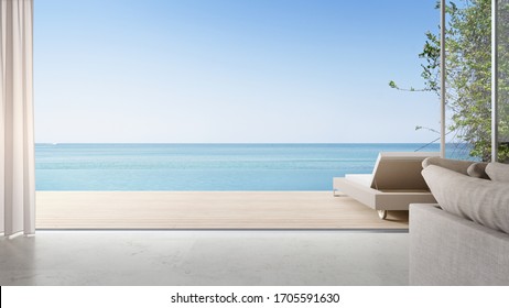 Lounge Chair On Terrace Near Bright Living Room And Sofa In Modern Beach House Or Luxury Pool Villa. Cozy Home Interior 3d Rendering With Sea View.