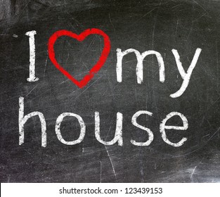 I Love My House Handwritten With White Chalk On A Blackboard.