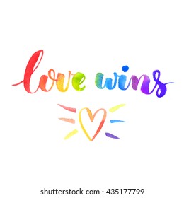 Love wins. Inspirational quote. Brush lettering with rainbow watercolor texture and hand drawn heart. Symbol of gay marriage, rights equality