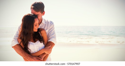 Loving couple cuddling at the beach - Powered by Shutterstock