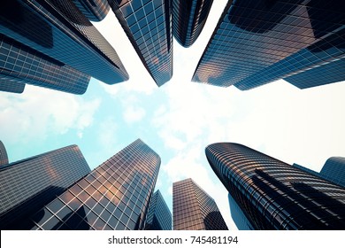 Low angle view of skyscrapers. Skyscrapers at sunset looking up perspective. Bottom view of modern skyscrapers in business district in evening light at sunset. Business concept of success industry