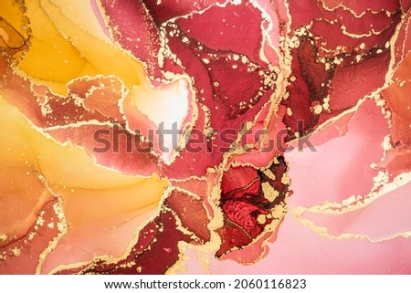 Luxury abstract fluid art painting background in alcohol ink technique, mixture of pink, maroon and yellow paints with golden veins. Transparent overlayers of ink create lines and gradients. 