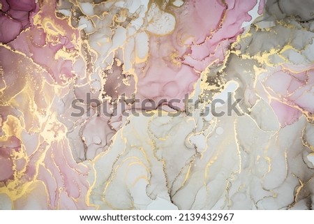 Luxury abstract painting in fluid art technique.Transparent layers of pastel lilac and gold paints create marbled texture of stripes, swirls and veins with glowing gold and glitter. Natural beauty