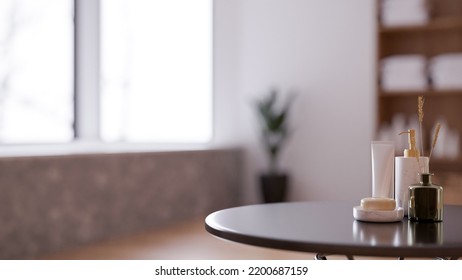 Luxury Bath Products, Soap, Shampoo, Body Lotion And Room Aroma Diffuser On The Table Over Blurred Modern Bathroom In Background. 3d Rendering, 3d Illustration