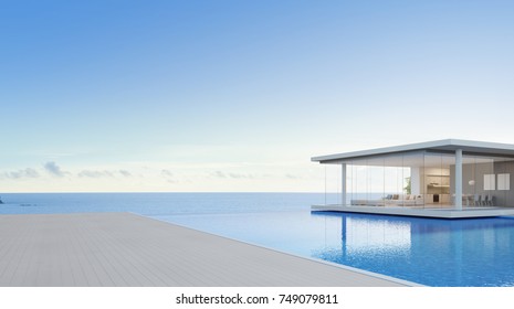 Luxury Beach House And Sea View Swimming Pool Near Empty Wooden Floor Deck In Modern Design, Vacation Home Or Hotel For Big Family With Blue Sky Background - 3d Illustration Of Holiday Villa Exterior